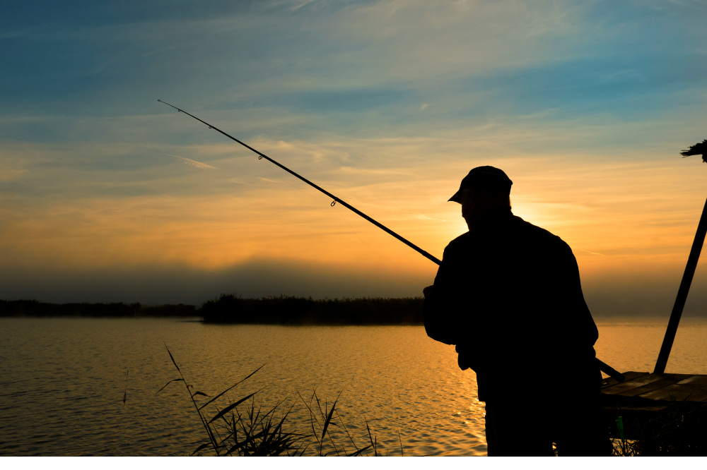 a man fishing in the lake district